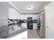 Kitchen featuring bright white cabinets, stainless steel refrigerator and stylish black backsplash at 5099 Leeshire Trce, Tucker, GA 30084
