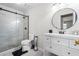 This bathroom features a glass shower and a round mirror above the sink at 1208 Lauren Nw Ct, Acworth, GA 30101