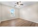 This is an empty bedroom with wood floors and a large window at 1208 Lauren Nw Ct, Acworth, GA 30101