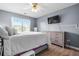 This bedroom features wood floors, light gray walls, a ceiling fan, and a large window at 1208 Lauren Nw Ct, Acworth, GA 30101