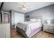 This bedroom offers light gray walls, wood flooring, and a ceiling fan at 1208 Lauren Nw Ct, Acworth, GA 30101