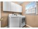 Laundry room with white cabinets, washer, and dryer at 1208 Lauren Nw Ct, Acworth, GA 30101