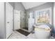 Bright main bathroom with a soaking tub and walk-in shower at 1208 Lauren Nw Ct, Acworth, GA 30101