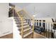 View of the staircase with wrought iron railings overlooking the living room at 1208 Lauren Nw Ct, Acworth, GA 30101