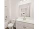 Bathroom features a vanity with white cabinets and a mirror with stainless steel fixtures at 1838 Lacebark Elm Way, Lawrenceville, GA 30045