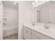 Bright bathroom featuring a double sink vanity with modern faucets and a tub-shower combo at 1838 Lacebark Elm Way, Lawrenceville, GA 30045