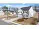 Charming two-story home boasts a light brick facade, a two-car garage, and manicured front yard at 1838 Lacebark Elm Way, Lawrenceville, GA 30045