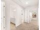 Hallway with neutral carpet leading to bath and bedrooms, showcasing the interior layout at 1838 Lacebark Elm Way, Lawrenceville, GA 30045
