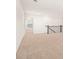 Bright hallway with neutral carpet leading to bedrooms and featuring a railing at 1838 Lacebark Elm Way, Lawrenceville, GA 30045