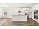Modern kitchen featuring stainless steel appliances, a center island, and an open layout at 1838 Lacebark Elm Way, Lawrenceville, GA 30045