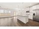 Modern kitchen featuring stainless steel appliances, a center island, and an open layout at 1838 Lacebark Elm Way, Lawrenceville, GA 30045