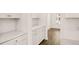 Modern kitchen with white cabinets, tile backsplash, and stainless hardware at 1838 Lacebark Elm Way, Lawrenceville, GA 30045