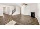 Open floor plan with living room, fireplace, and staircase with views to entry at 1838 Lacebark Elm Way, Lawrenceville, GA 30045