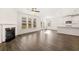 Living room with fireplace, ceiling fan, and view of kitchen and sliding glass doors to patio at 1838 Lacebark Elm Way, Lawrenceville, GA 30045