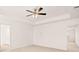 Spacious main bedroom showcasing a ceiling fan, large windows, and a doorway to the ensuite bathroom, providing comfort and convenience at 1838 Lacebark Elm Way, Lawrenceville, GA 30045