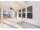 Covered patio with white pillars, ceiling fan, and view of backyard at 1838 Lacebark Elm Way, Lawrenceville, GA 30045