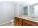 Bathroom with double vanity, granite countertop, and wood cabinets at 2715 Maple Park Pl # 30, Cumming, GA 30041