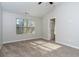 Bright bedroom featuring a large window, neutral carpet, and vaulted ceiling at 2715 Maple Park Pl # 30, Cumming, GA 30041
