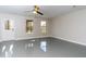 Bonus room with gray floors, two windows, a ceiling fan, and an exterior door at 2715 Maple Park Pl # 30, Cumming, GA 30041