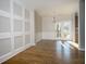 Dining room featuring hardwood floors, white wainscoting, and natural light from the sliding door to the deck at 2715 Maple Park Pl # 30, Cumming, GA 30041