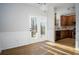 Open kitchen and dining area with hardwood floors and deck access through glass paneled doors at 2715 Maple Park Pl # 30, Cumming, GA 30041