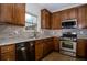 Well-lit kitchen featuring wood cabinets, stainless steel appliances, and granite countertops at 2715 Maple Park Pl # 30, Cumming, GA 30041