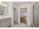 Elegant bathroom with double vanity, glass shower, and access to walk-in closet and bedroom at 1828 Lacebark Elm Way, Lawrenceville, GA 30045