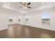 Bright and airy bedroom with hardwood floors, a ceiling fan, and plenty of natural light at 1828 Lacebark Elm Way, Lawrenceville, GA 30045