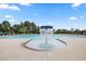 Large community pool with a fountain feature and plenty of lounge chairs for residents at 1828 Lacebark Elm Way, Lawrenceville, GA 30045