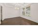 Bright dining room with hardwood floors, decorative lighting, and a large window at 1828 Lacebark Elm Way, Lawrenceville, GA 30045