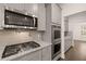 Modern kitchen with stainless steel appliances and granite countertops provides a luxurious cooking space at 1828 Lacebark Elm Way, Lawrenceville, GA 30045