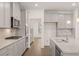 Modern kitchen with stainless steel appliances, granite countertops, gray cabinets, and hardwood flooring at 1828 Lacebark Elm Way, Lawrenceville, GA 30045