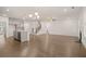 Open-concept living area with hardwood floors, kitchen island, staircase, and fireplace at 1828 Lacebark Elm Way, Lawrenceville, GA 30045