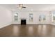 Spacious living room with hardwood floors, a fireplace, recessed lighting, and large windows at 1828 Lacebark Elm Way, Lawrenceville, GA 30045