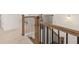 Staircase with wooden railing and black balusters leading to the upper level of the house at 1828 Lacebark Elm Way, Lawrenceville, GA 30045