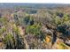 Scenic aerial view displays mature trees surrounding the house, creating a private and tranquil setting at 2790 Collier Nw Dr, Atlanta, GA 30318