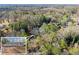 Aerial view showing house nestled among mature trees and a close-up of house with charming curb appeal at 2790 Collier Nw Dr, Atlanta, GA 30318