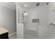 Elegant bathroom featuring a large frameless glass shower, bench, and custom tile design at 2790 Collier Nw Dr, Atlanta, GA 30318