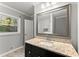 Bathroom featuring a granite countertop, modern fixtures, and a window view at 2790 Collier Nw Dr, Atlanta, GA 30318