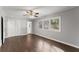 Bedroom with a ceiling fan, hardwood floors, neutral wall paint, and double closet doors at 2790 Collier Nw Dr, Atlanta, GA 30318