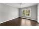 Neutral bedroom with hardwood floors, a ceiling fan and a view from the window at 2790 Collier Nw Dr, Atlanta, GA 30318