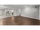 Open living room showcasing the hardwood floors and seamless transition to the adjacent kitchen with stainless steel appliances at 2790 Collier Nw Dr, Atlanta, GA 30318