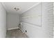 Small utility room with painted white brick, wooden floor, shelf, and exposed utility connections at 2790 Collier Nw Dr, Atlanta, GA 30318