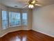 Inviting bedroom featuring hardwood floors, natural light from its windows, and a ceiling fan at 3015 Camden Way, Alpharetta, GA 30005