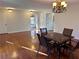 Inviting dining area with wood floors and an elegant chandelier, perfect for Gathering meals at 3015 Camden Way, Alpharetta, GA 30005