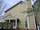 Exterior view showing the side and back of the home with light colored siding and mature trees at 3015 Camden Way, Alpharetta, GA 30005
