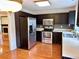 Updated kitchen featuring stainless steel appliances, dark cabinetry, and a tile backsplash at 3015 Camden Way, Alpharetta, GA 30005