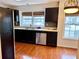 Well-lit kitchen featuring stainless steel appliances, dark cabinetry, and views of the outside at 3015 Camden Way, Alpharetta, GA 30005