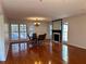 Bright living room featuring hardwood floors, a fireplace, and large windows with natural light at 3015 Camden Way, Alpharetta, GA 30005