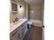 Well lit bathroom with white quartz countertop, modern fixtures, and neutral tiling at 4829 Woodhurst Way, Stone Mountain, GA 30088